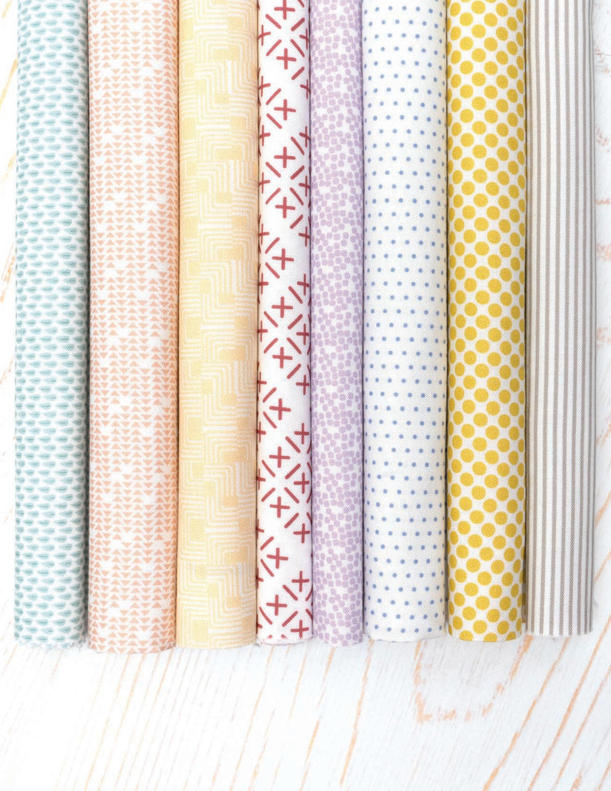 Gathered Bonbons quarter metre bundle by Jen Kingwell for Moda – the eight background fabrics shown from a second angle, in stone, citrine, lavender, lilac, blush, butterscotch, apricot and sage