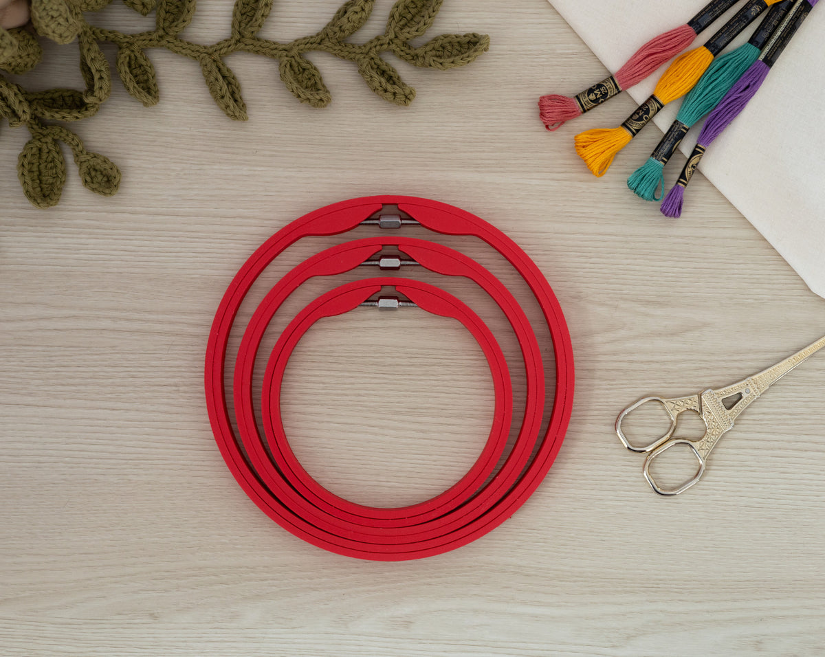 Matte Scarlet Red embroidery hoops styled with fabric, thread and scissors