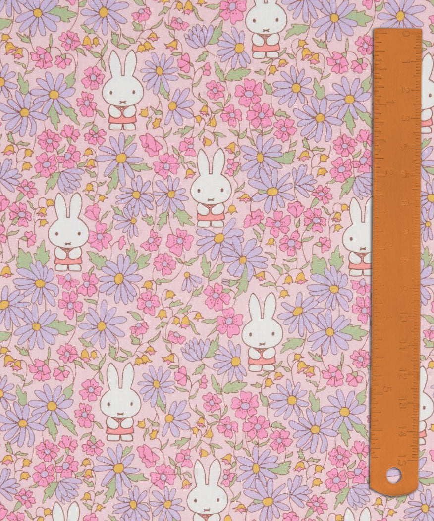 Liberty x Miffy Prairie Day Tana Lawn in blossom pink, with pink and lilac daisies, shown with a ruler for scale