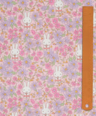 Liberty x Miffy Prairie Day Tana Lawn in blossom pink, with pink and lilac daisies, shown with a ruler for scale