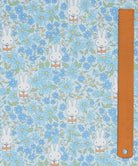 Liberty x Miffy Prairie Day Tana Lawn in pale sky blue, with cornflowers and blue daisies, shown with a ruler for scale