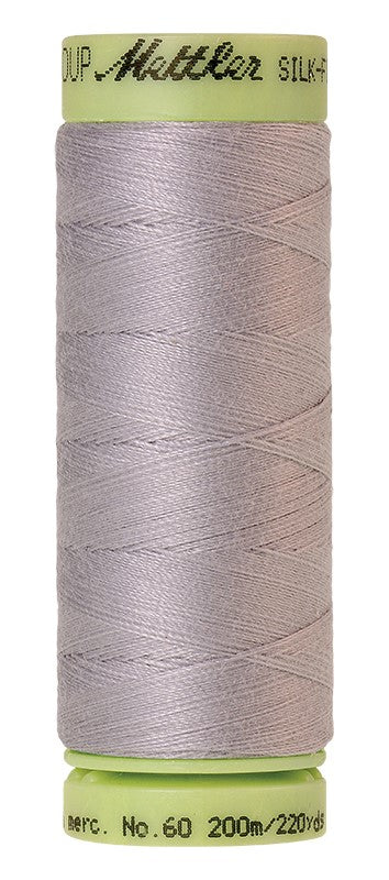 A spool of Mettler Silk-Finish Cotton 60 weight thread, 200m, in Ash 2791 — a soft pale grey.