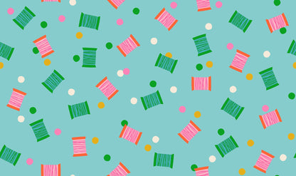 Spools in Cloudless quilting cotton by Ruby Star Society — spools of thread tossed across the cloth in a rainbow of colours on a clear sky blue