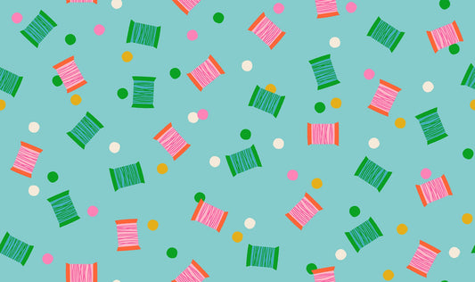 Spools in Cloudless quilting cotton by Ruby Star Society — spools of thread tossed across the cloth in a rainbow of colours on a clear sky blue